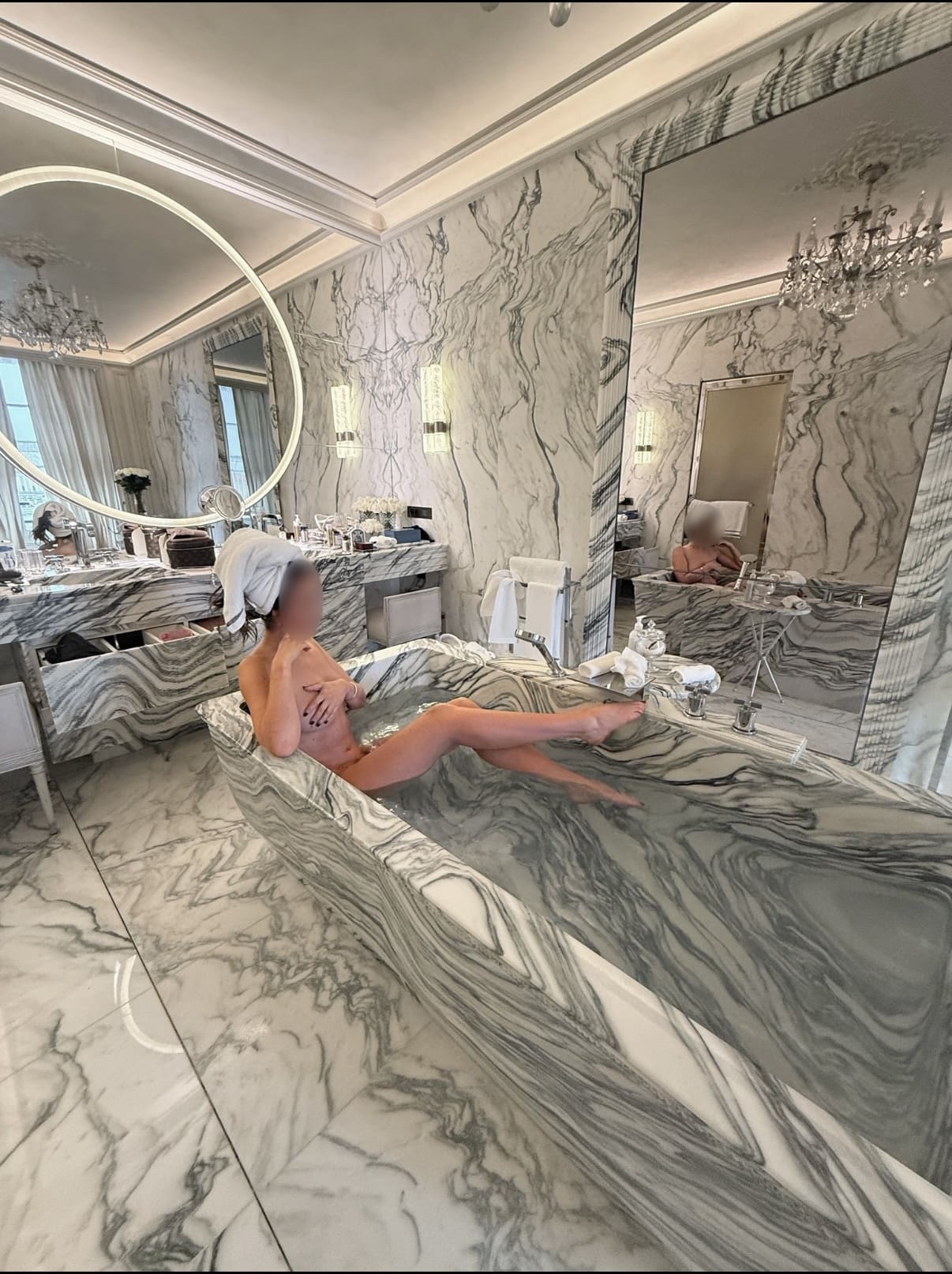 Eve Mae high class escort relaxing in a luxury hotel suite